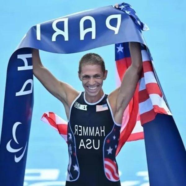 Chris Hammer celebrates his gold medal in the triathlon at the Paris Paralympic Games